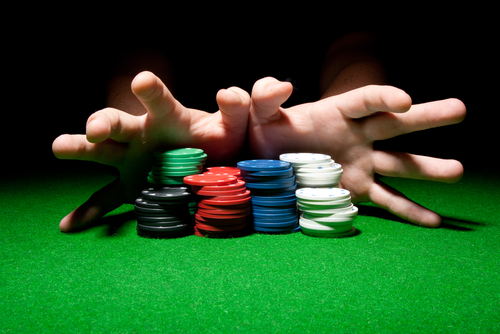 Hands pushing poker chips for an all-in