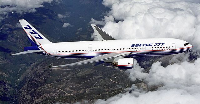 A Boeing 777 in flight over the mountains (From Wikipedia)