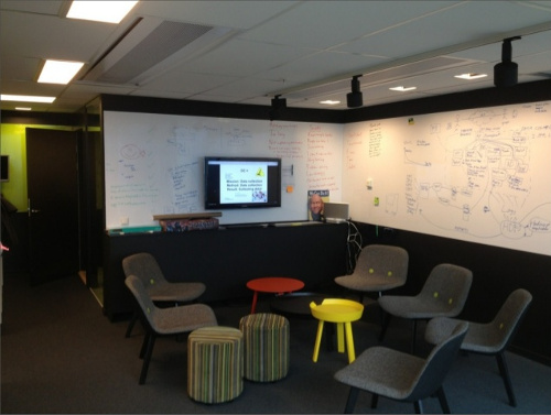Team gathering area with writable walls and a wall screen at spotify