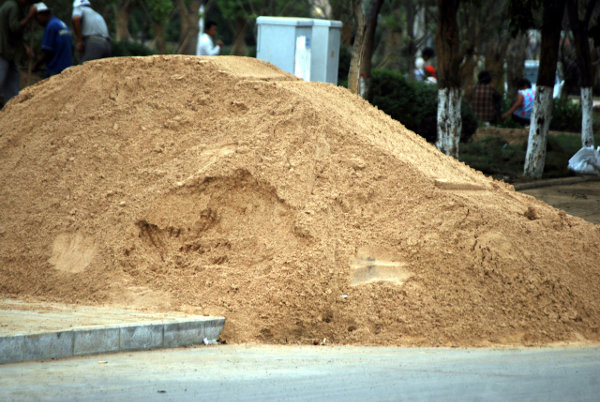 A sand pile on the pavement