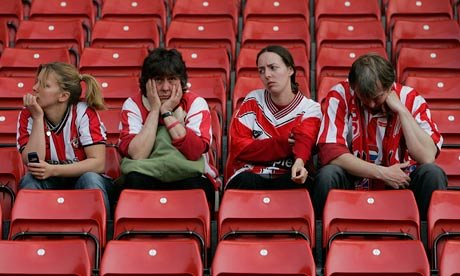 A team of sad fans, looking like lost zombies