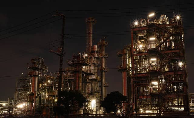 Picture of a factory running by night. Discussing big changes to the existing, and running, system can be stressful for developers. A good Event Storming tip is to make all the stress points explicit.
