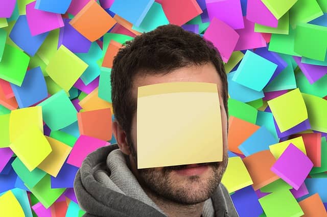 Picture of a guy in front of a wall full of sticky-notes and with a large sticky on his head too! Event Storming already has a complex post-it bestiary, adding a new one is not a good idea.