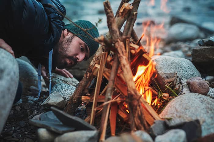 Picture of a camper tending the campfire. Doing regular mob session keeps coding standards and conventions in everyone's mind, a bit like stories around the campfire has been used to keep oral tradition alive for thousands of years