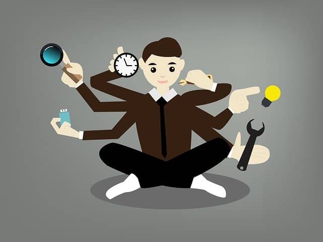 Drawing of a man with 6 harms dealing with many tasks at the same time. As a tech lead, it's easy to suffer from stressful task switching.