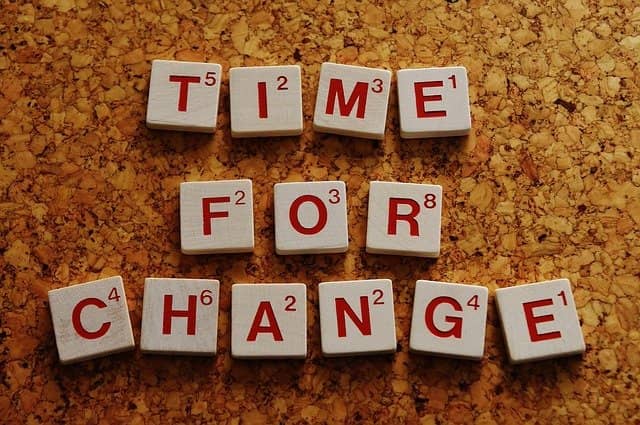 Photograph of scrabble letters forming the word 'Time for a change'. As technical agile coach, we bring change. Change is not easy most of the time.