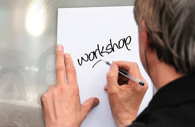 Picture of a man writing 'workshop' on a whiteboard on the wall. Example-Mapping is a very lightweight conversation format to capture the details of a user story.