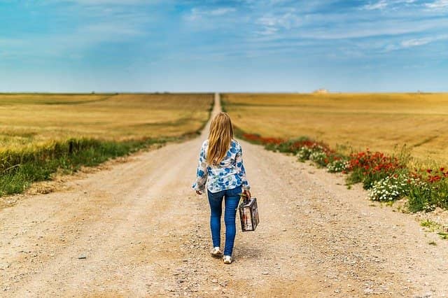 Photo of a girl carrying a suitcase and walking away. If laggards make coaching a team too exhausting, remember that leaving must remain an option.