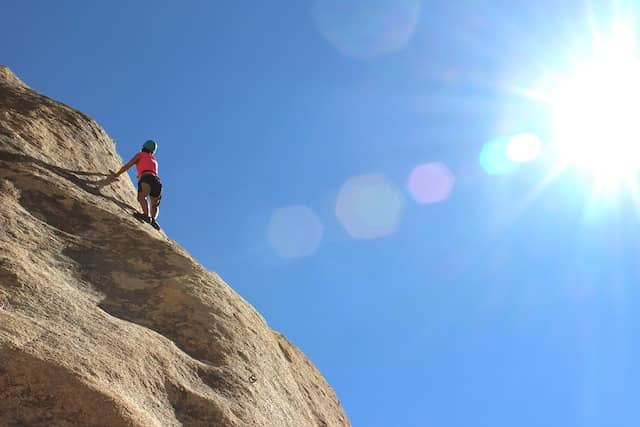 Photograph of a rock climber nearing the horizon. Increasing developers' role in sprint plannings is a long-term endeavor. Each of these workshops should get you closer, one step at a time.