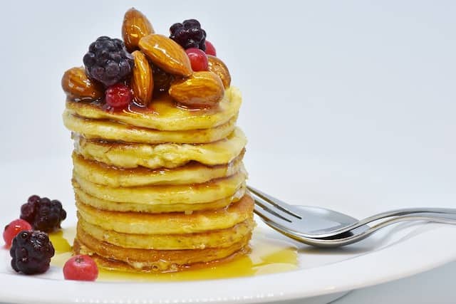 A giant pile of pancakes with almonds, fruits, and covered in honey. Sometimes, technical work items are just too large to swallow in small chunks...