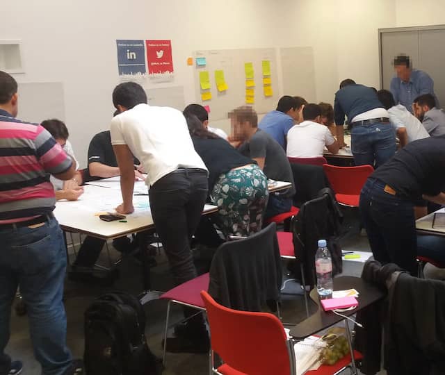 A training room with many teams playing the built-in quality game at the same time