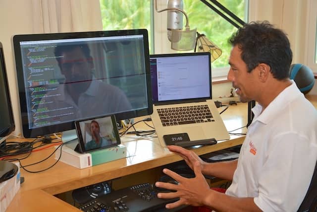 Photo of Justin's Gordon remote pair programming setup that uses a tablet bellow the screen to enable eye contact while coding