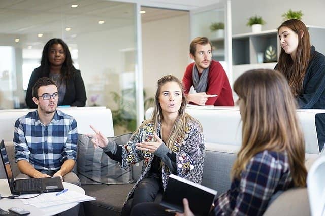 Photo of a team engaged in a brainstorming discussion. Brainstorming is not a very effective way to write team coding conventions