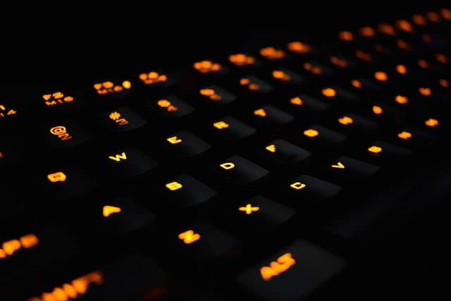 Photo of a backlit mechanical keyboard. Mob programming turns the driver into a smart keyboard able to read our minds