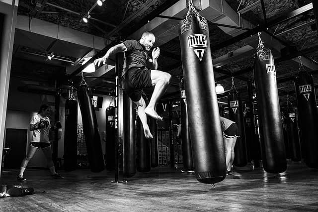 Photo of a dojo with people training for kids on punch bags. Likewise, there is no risk of getting hurt in the coding dojo.