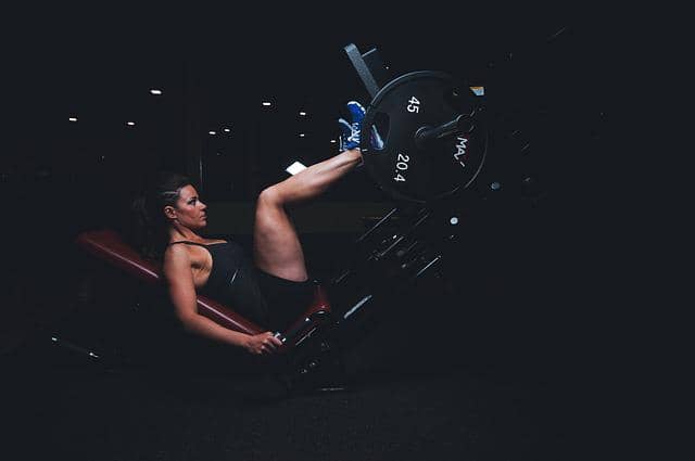 Photo of a woman during a workout on a machine. Adding TCR to code kata sessions is like adding weights, it makes session more intense, but also speeds up the development of baby-steps muscles.