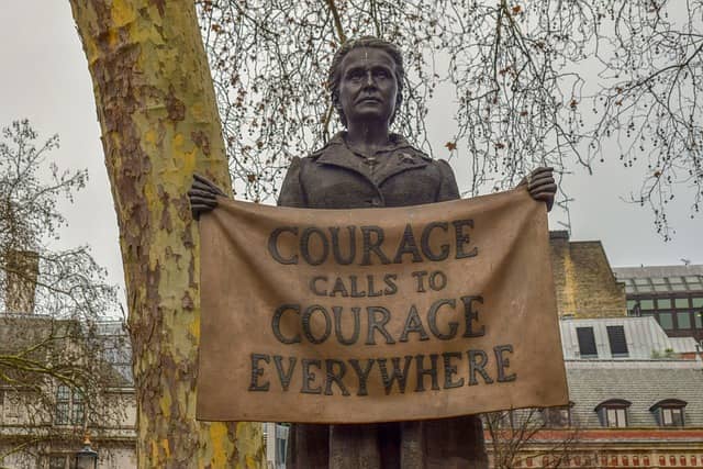 Photo of a statue of Millicent Fawcett holding a banner 'Courage calls to courage everywhere'