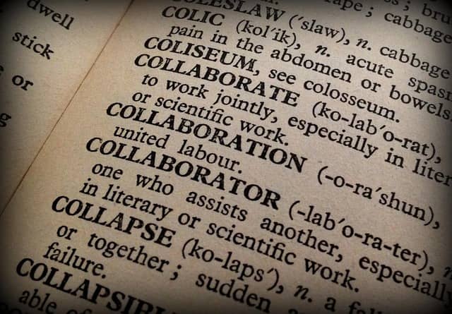 Photo of a dictionary page opened at words Collaborate, Collaboration, and Collaborator. The definition for Collaborator is "One who assists another, especially in literary or scientific work."